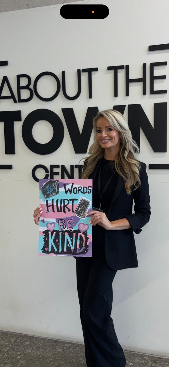 Bev holding a “Words hurt, be kind” poster at ATT Central for #HashtagGirls