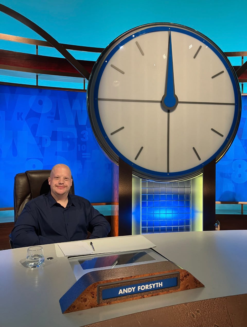 Andy Forsyth smiling at his desk on the Countdown set