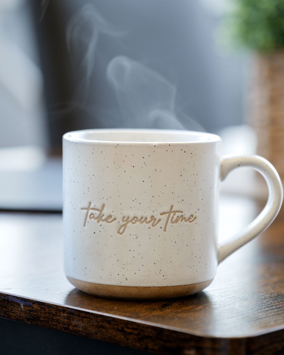 A steaming “take your time” mug on a table at ATT Central
